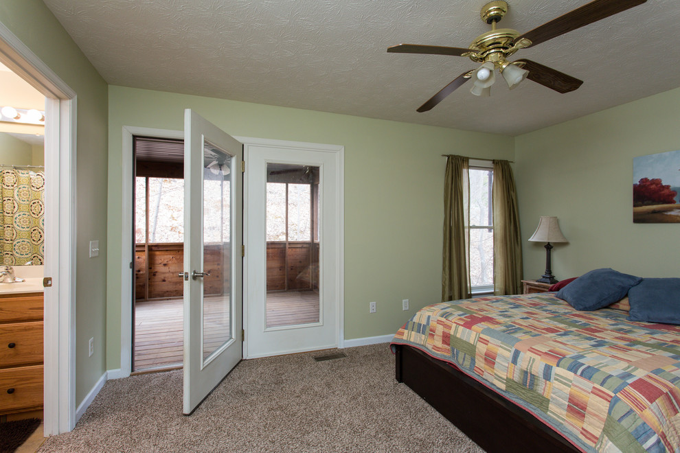Example of a large transitional master carpeted bedroom design in Other with green walls and no fireplace