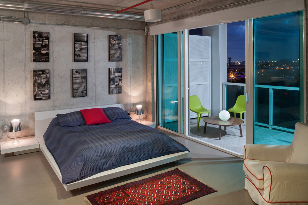 Diseño de dormitorio industrial sin chimenea con paredes grises y suelo de cemento