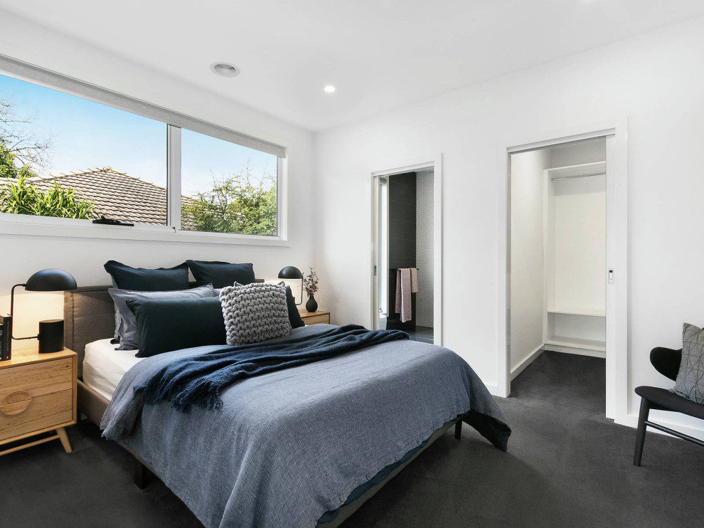 Photo of a medium sized victorian guest bedroom in Melbourne with grey walls, carpet and grey floors.