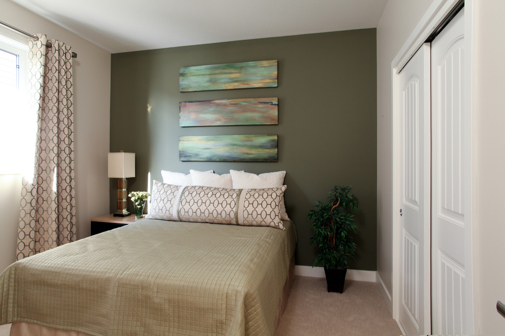 Design ideas for a traditional guest bedroom in Calgary with green walls and carpet.