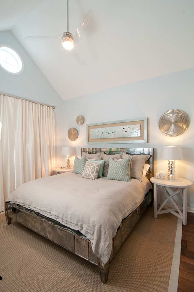 Design ideas for a coastal guest bedroom in Miami with dark hardwood flooring and blue walls.
