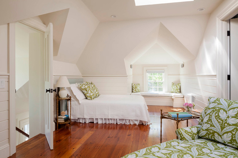 Mid-sized elegant guest medium tone wood floor bedroom photo in Boston with white walls