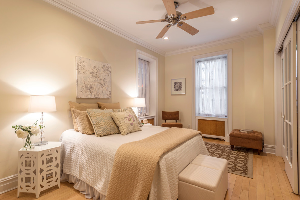 Inspiration for a mid-sized contemporary guest light wood floor bedroom remodel in New York with beige walls