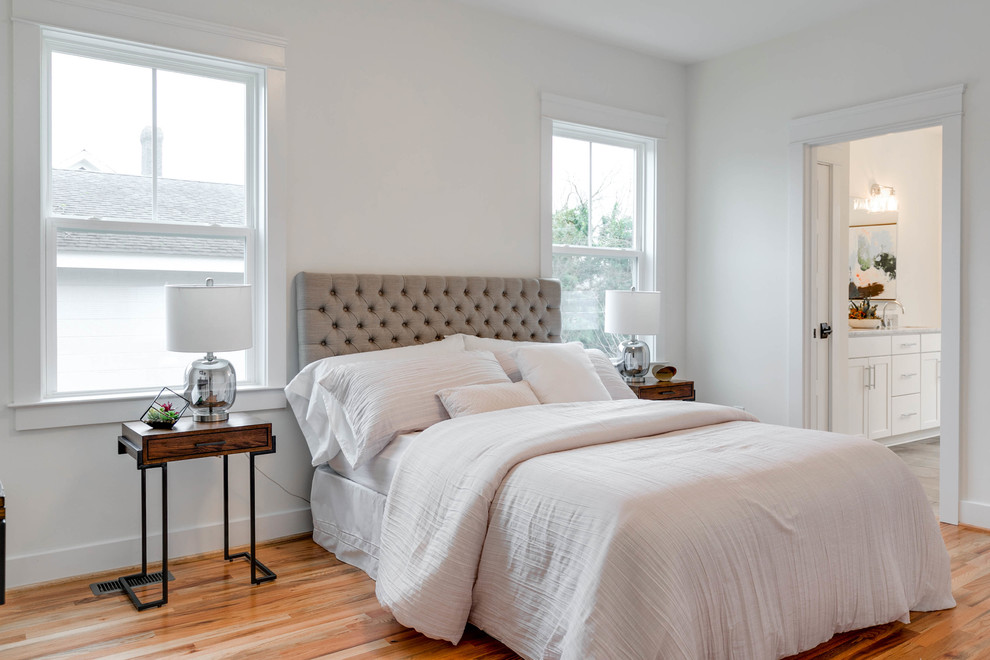 Photo of a medium sized scandi master bedroom in Richmond with white walls and light hardwood flooring.