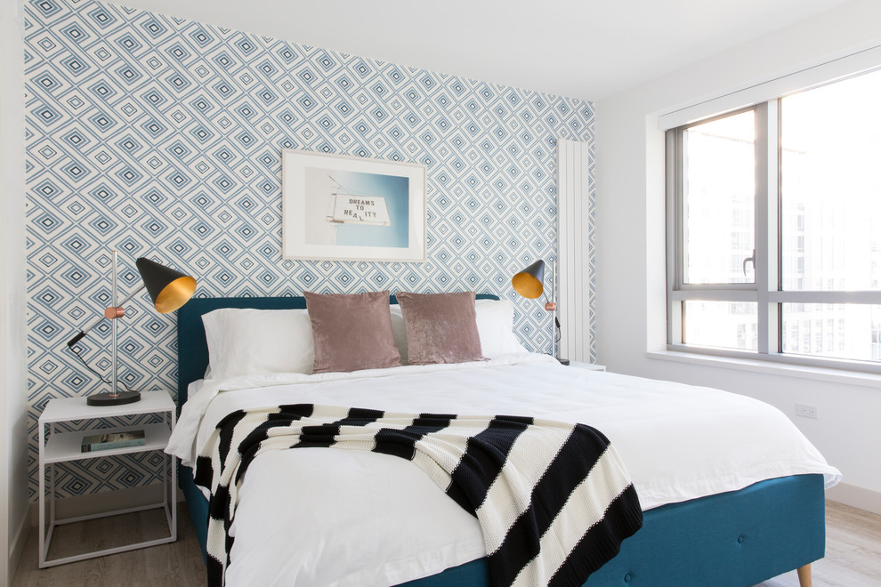 Imagen de dormitorio contemporáneo sin chimenea con paredes multicolor y suelo de madera clara