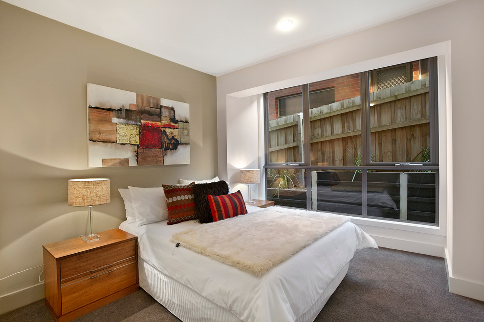 Inspiration for a mid-sized contemporary carpeted bedroom remodel in Melbourne with beige walls
