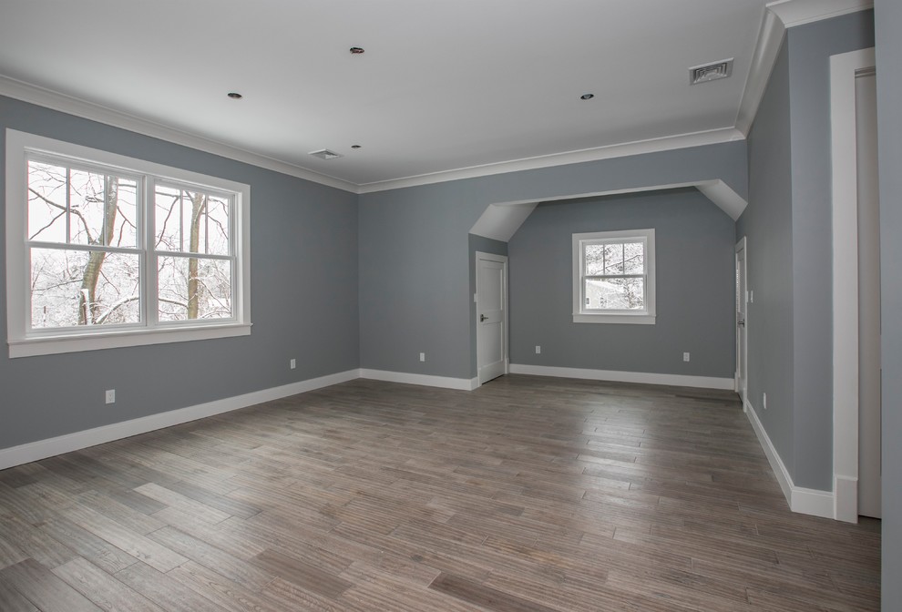 Foto de habitación de invitados campestre de tamaño medio sin chimenea con paredes azules, suelo vinílico y suelo gris