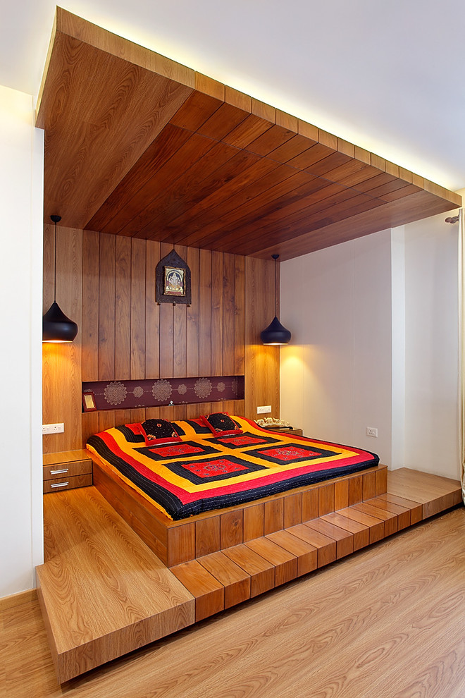 Пример оригинального дизайна: спальня в современном стиле с белыми стенами и паркетным полом среднего тона