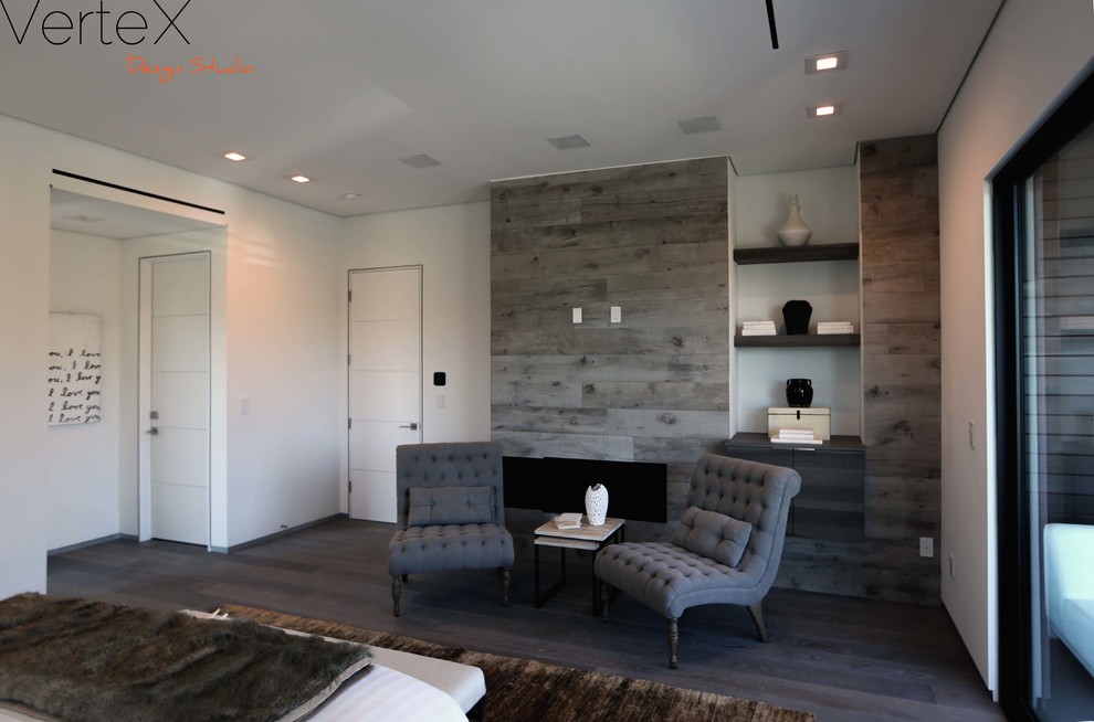 Idée de décoration pour une chambre parentale minimaliste de taille moyenne avec un mur blanc, un sol en bois brun, une cheminée standard et un manteau de cheminée en carrelage.