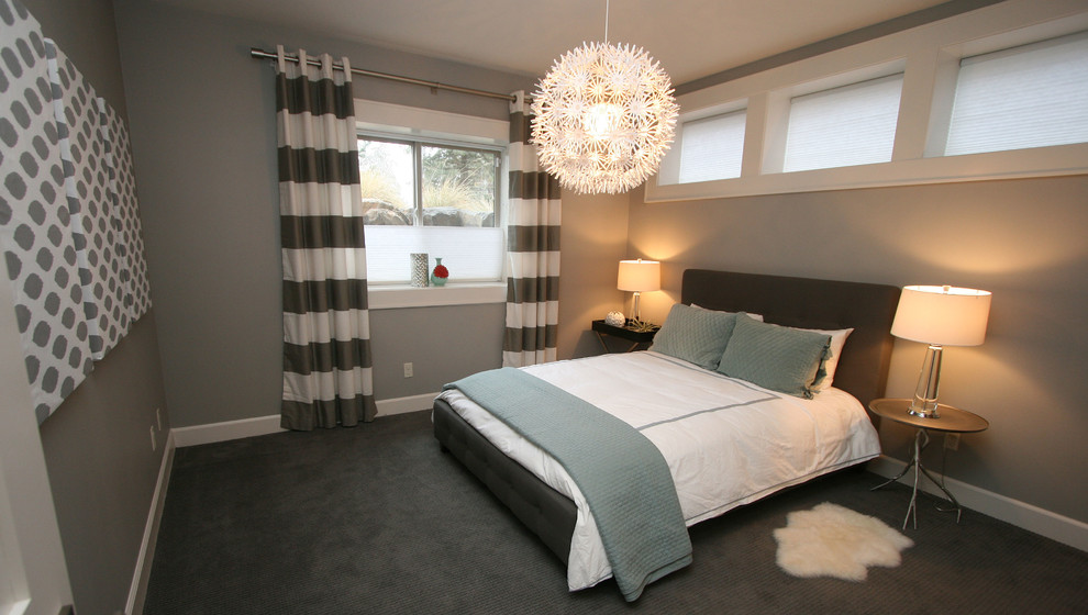 Ejemplo de habitación de invitados actual pequeña sin chimenea con paredes grises y moqueta