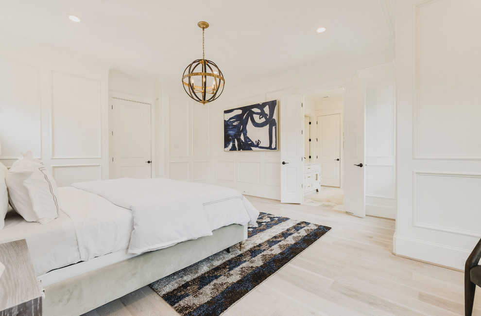 Large classic master bedroom in Houston with white walls, light hardwood flooring, no fireplace and brown floors.