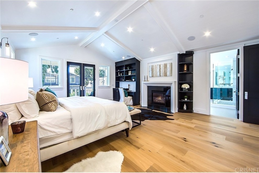 Inspiration for a farmhouse master bedroom remodel in Los Angeles with white walls