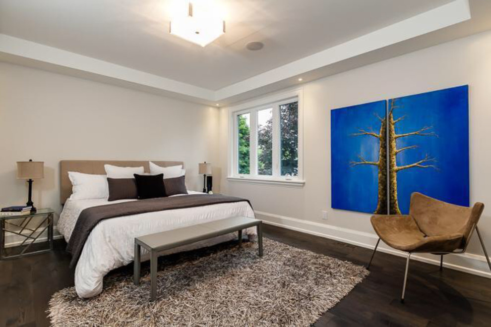 This is an example of a medium sized traditional master bedroom in Toronto with white walls and medium hardwood flooring.