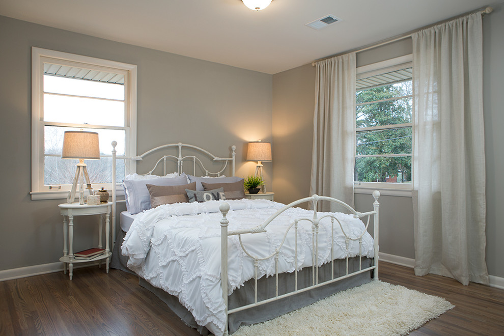 Small transitional guest medium tone wood floor bedroom photo in Nashville with gray walls