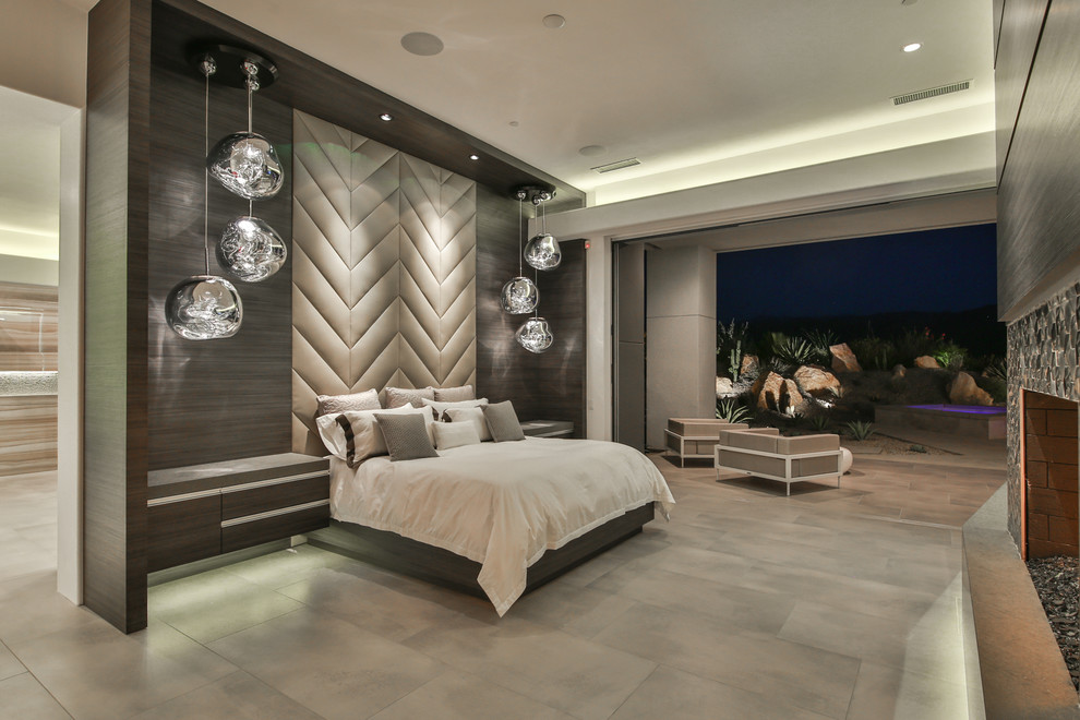 На фото: спальня в современном стиле с серыми стенами, стандартным камином и серым полом