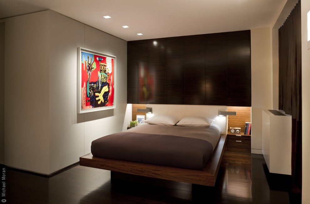 Bedroom - modern dark wood floor bedroom idea in New York with beige walls