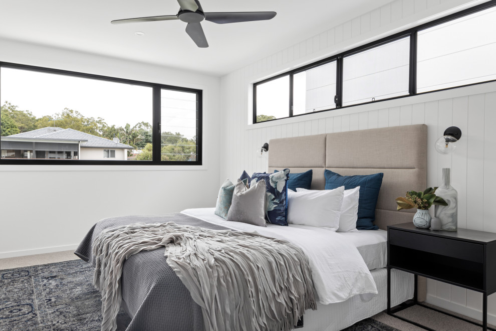 This is an example of a contemporary bedroom in Brisbane.