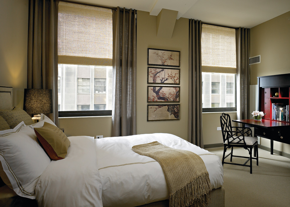 Contemporary bedroom in Chicago with beige walls and carpet.