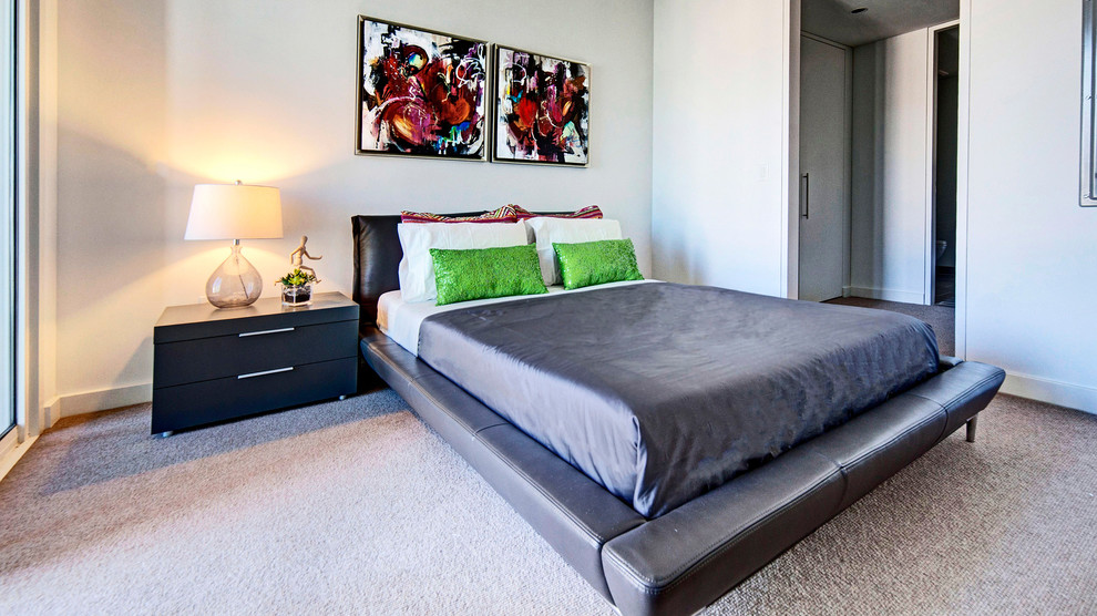 This is an example of a large modern master bedroom in Los Angeles with white walls, carpet and no fireplace.