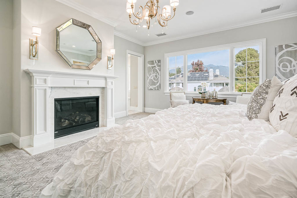 Bedroom - mid-sized transitional master carpeted and gray floor bedroom idea in Los Angeles with gray walls, a standard fireplace and a stone fireplace