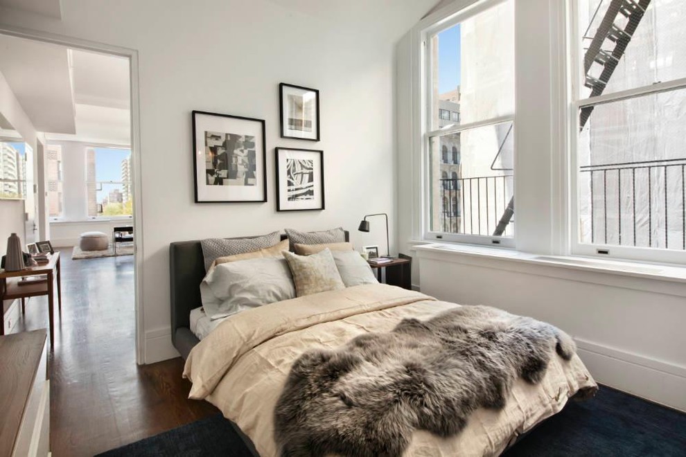 Inspiration for a contemporary bedroom remodel in New York with white walls