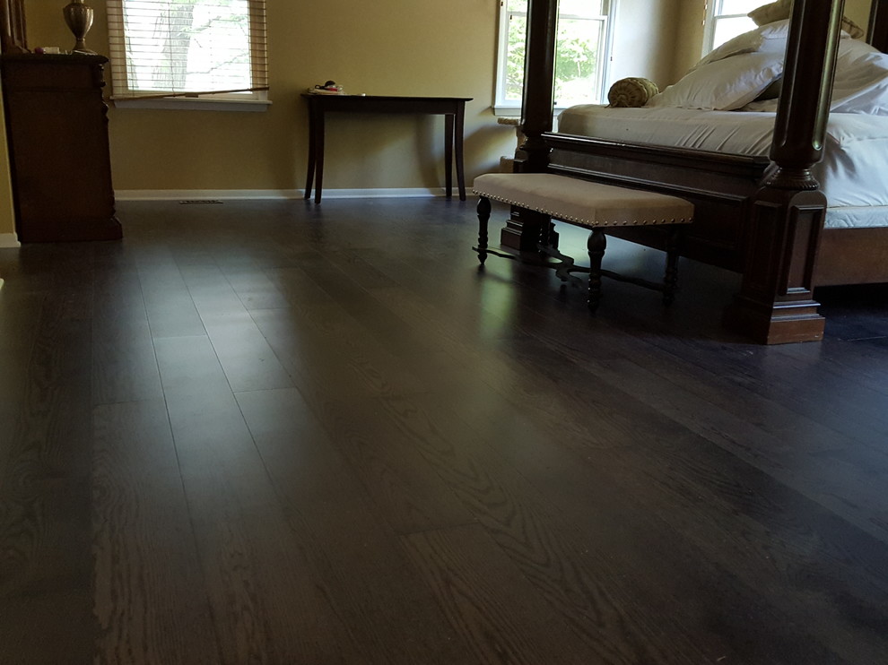 Inspiration for a timeless master dark wood floor and brown floor bedroom remodel in Chicago with beige walls