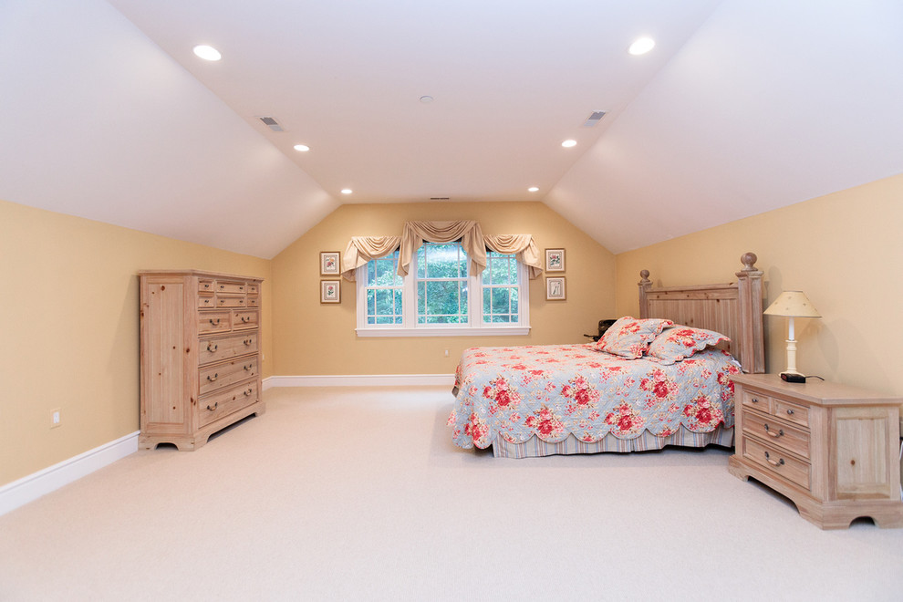 Inspiration for a large classic guest bedroom in Boston with yellow walls, carpet and beige floors.