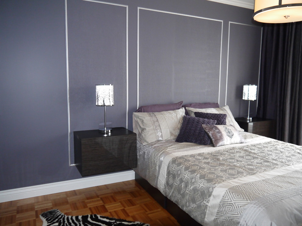На фото: большая хозяйская спальня в современном стиле с фиолетовыми стенами, светлым паркетным полом и горизонтальным камином