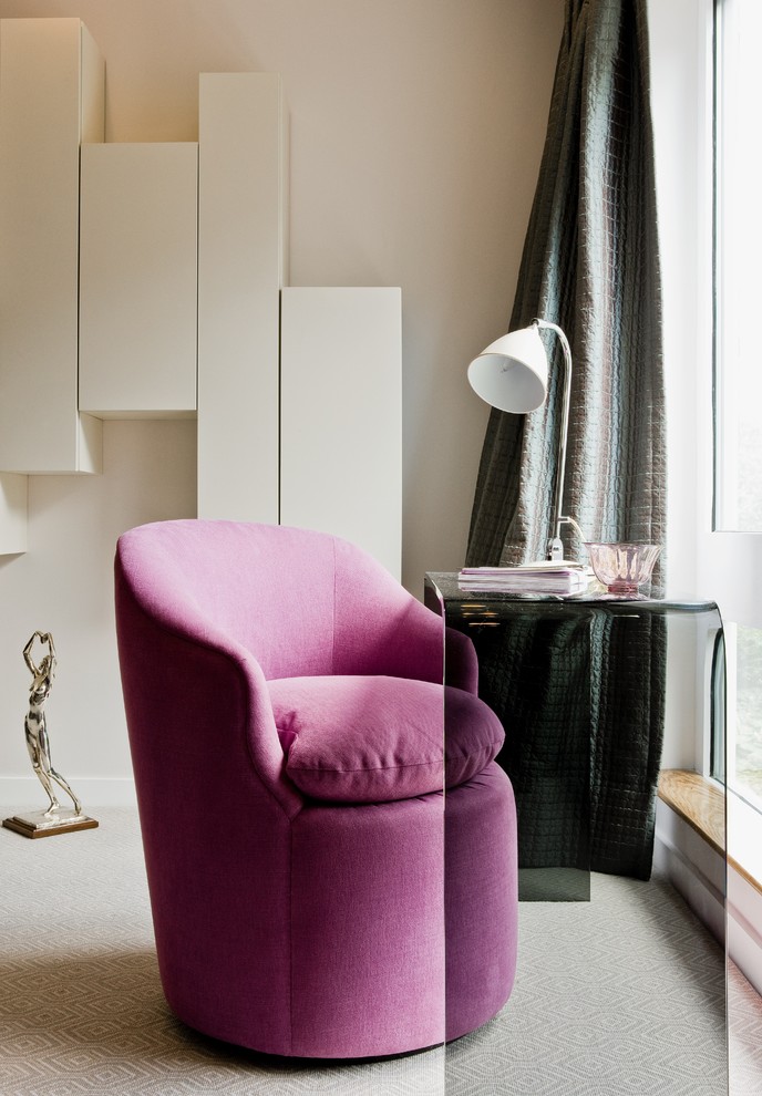 This is an example of a contemporary bedroom in Boston with beige walls and carpet.