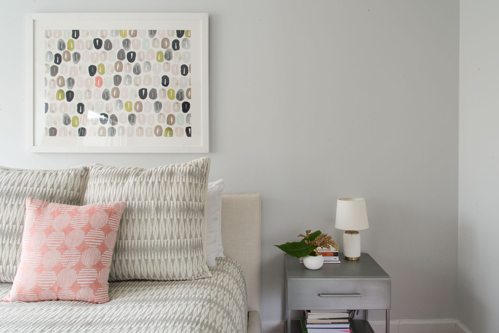 Mid-sized minimalist master medium tone wood floor bedroom photo in New York with gray walls