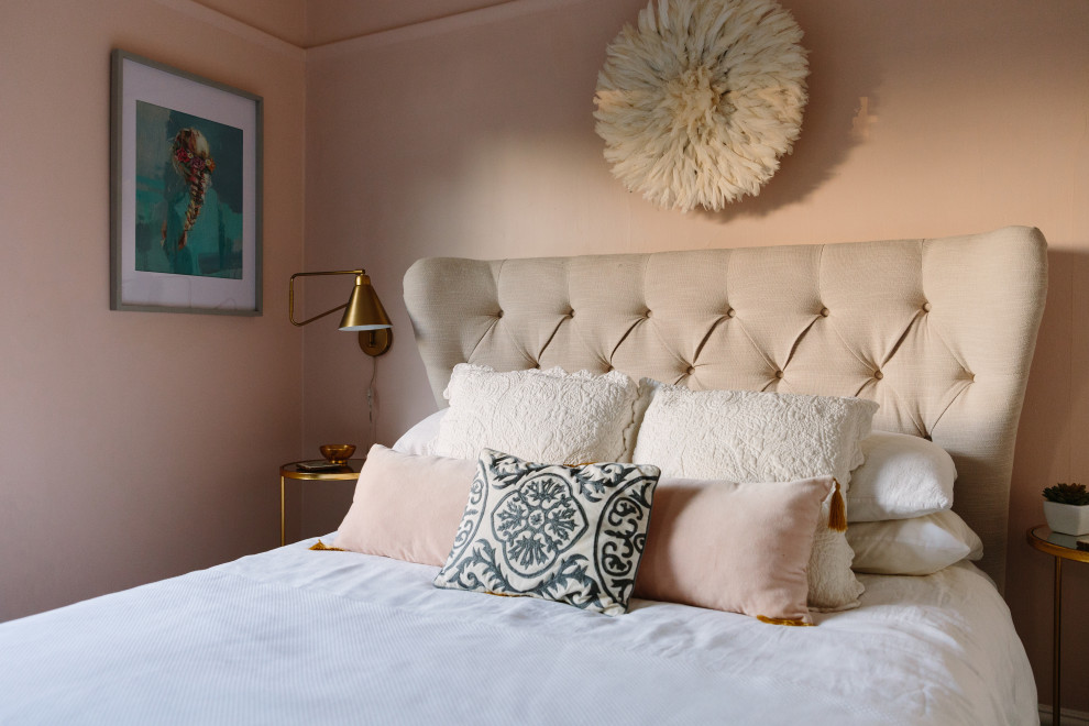 This is an example of a modern master and grey and pink bedroom in London with pink walls, carpet and grey floors.