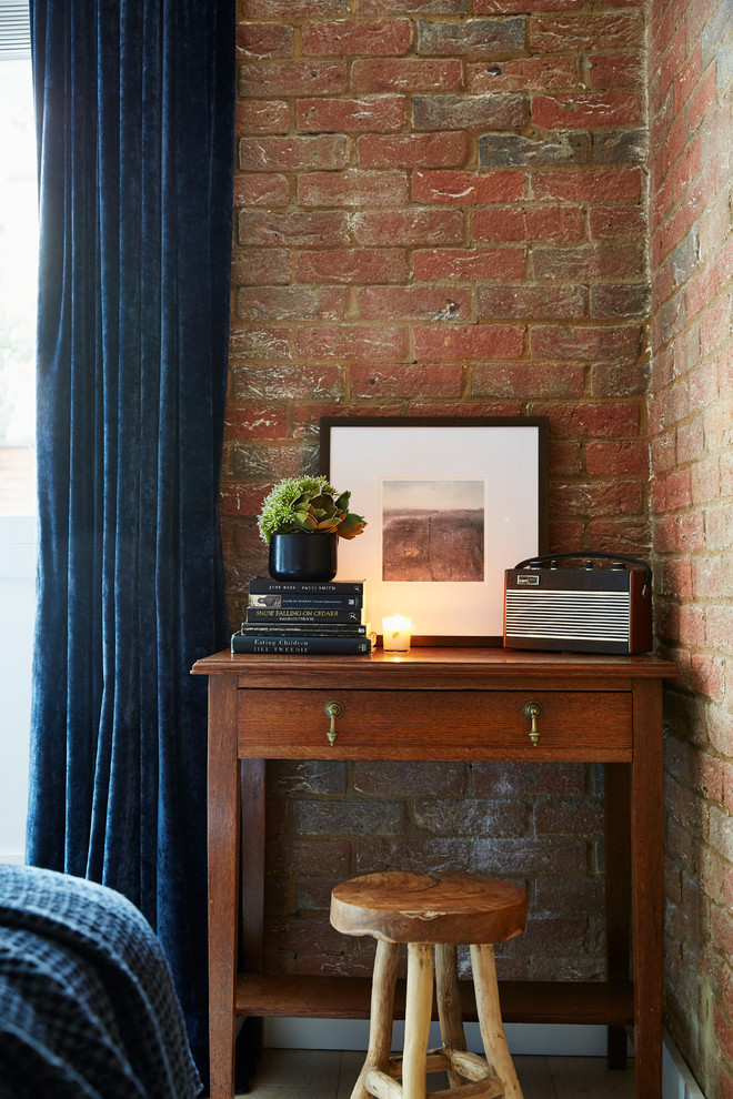 Trendy guest brick wall bedroom photo in London