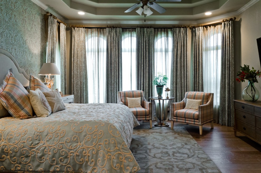 This is an example of a mediterranean bedroom in Austin with multi-coloured walls and dark hardwood flooring.