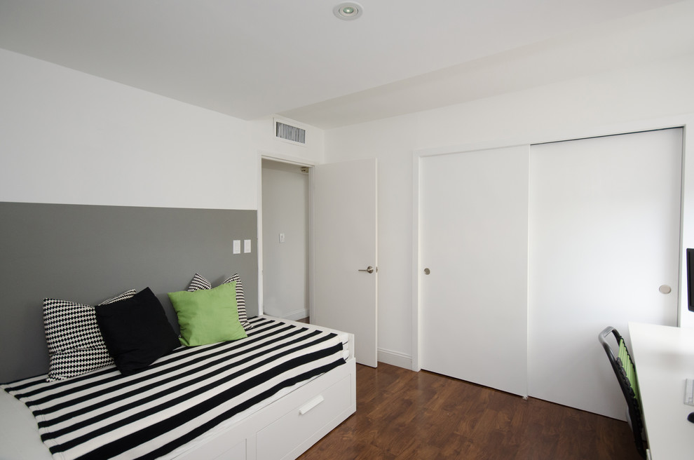Example of a mid-sized trendy guest dark wood floor bedroom design in Miami with white walls