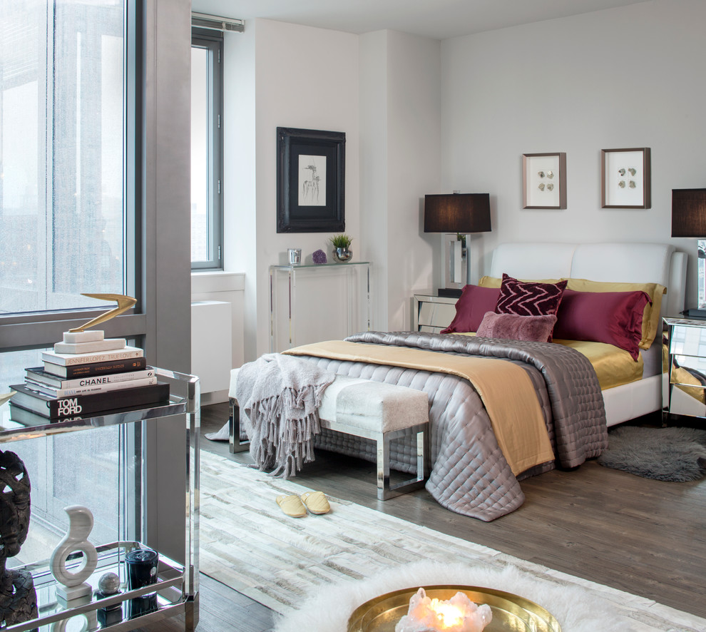 Photo of a contemporary master, grey and brown and grey and silver bedroom in New York with white walls and dark hardwood flooring.