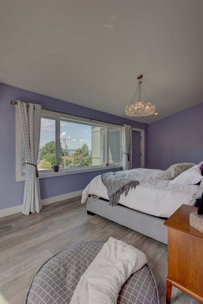 Example of a mid-sized master vinyl floor, gray floor and vaulted ceiling bedroom design in Seattle with purple walls