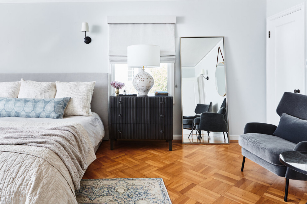 Imagen de dormitorio principal mediterráneo grande sin chimenea con paredes grises y suelo de madera clara