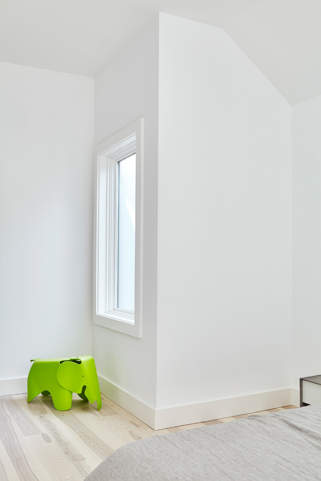 Modern inredning av ett litet huvudsovrum, med vita väggar, ljust trägolv och flerfärgat golv