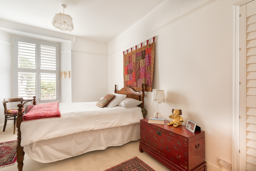 Inspiration for a mid-sized eclectic guest carpeted bedroom remodel in Devon with white walls