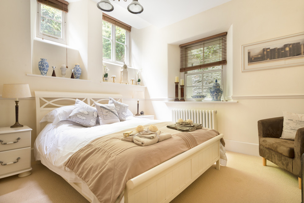 Design ideas for a medium sized contemporary guest bedroom in Devon with white walls and carpet.