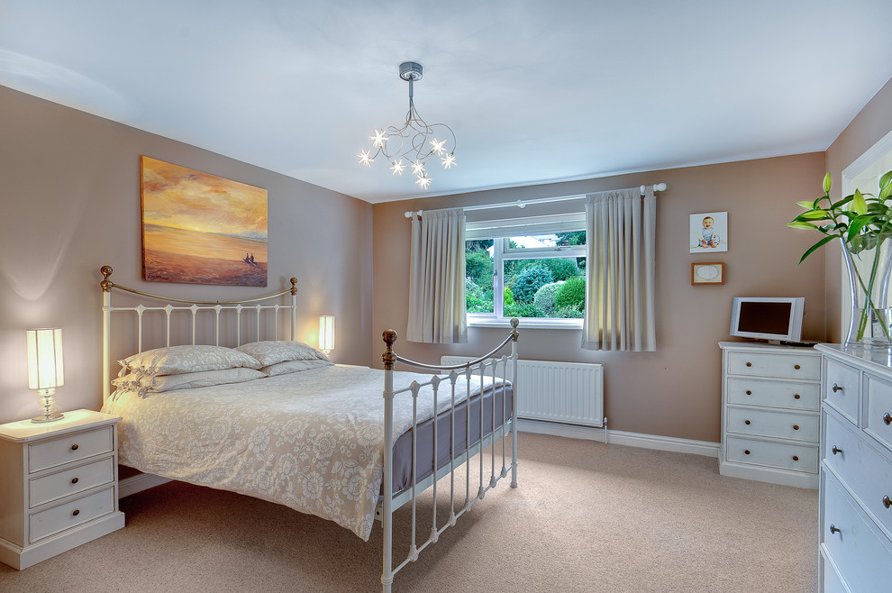 Bedroom - mid-sized modern bedroom idea in Devon with beige walls