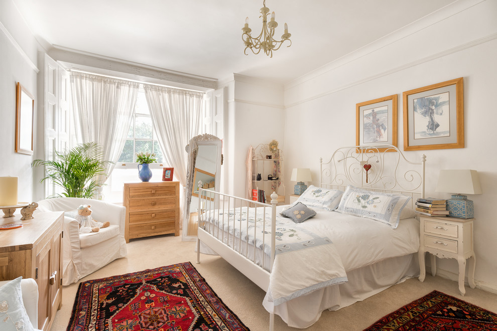 Design ideas for a medium sized victorian guest bedroom in Devon with white walls and carpet.