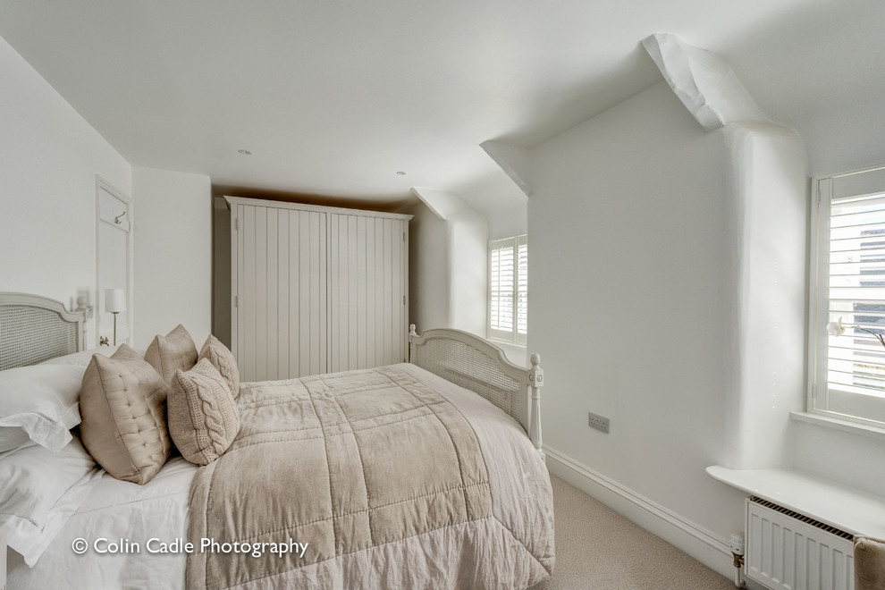 Bedroom - small master carpeted bedroom idea in Devon with white walls