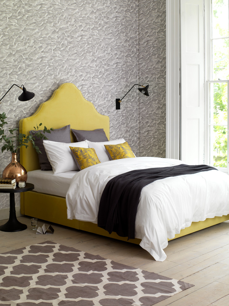 Mid-sized island style master bedroom photo in London with gray walls