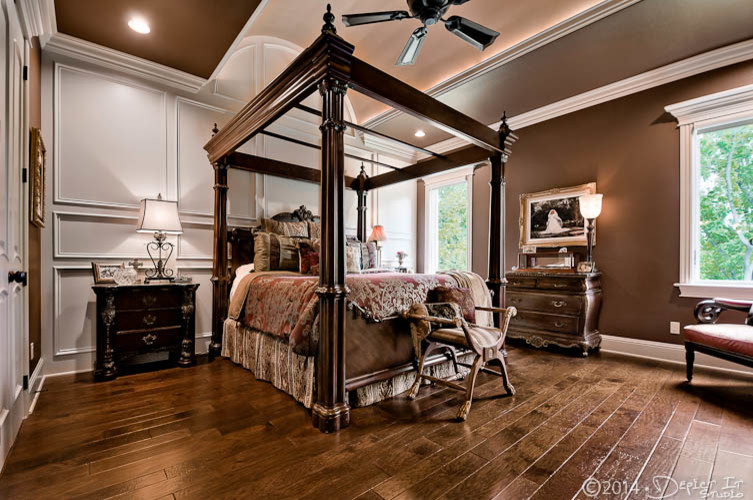 Classic master bedroom in Little Rock with medium hardwood flooring.