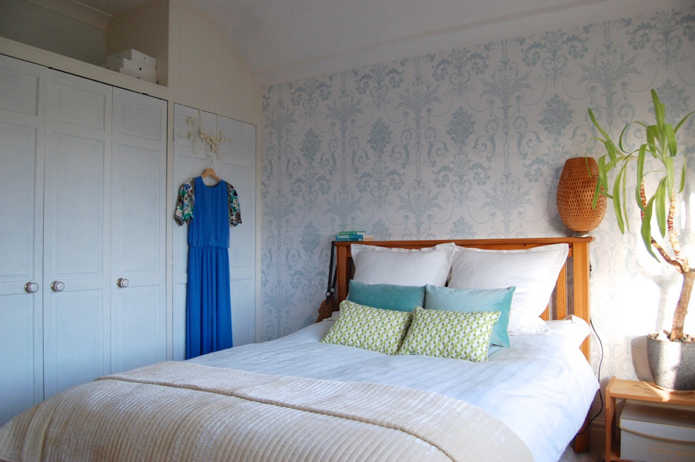 Photo of a medium sized beach style guest bedroom in Gloucestershire with blue walls, carpet and white floors.