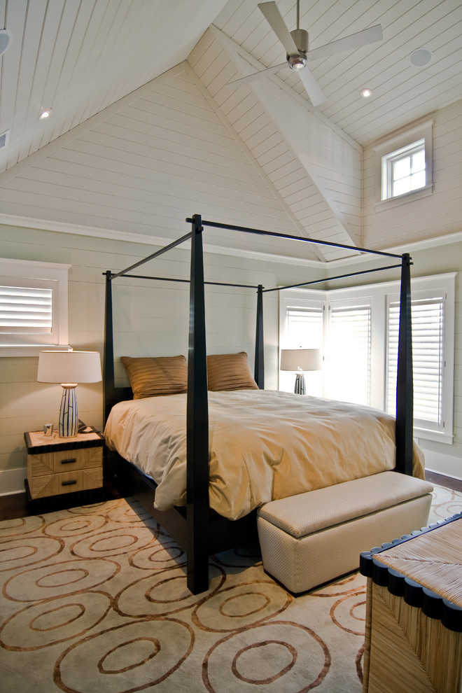 Diseño de dormitorio costero sin chimenea con paredes blancas y suelo de madera oscura