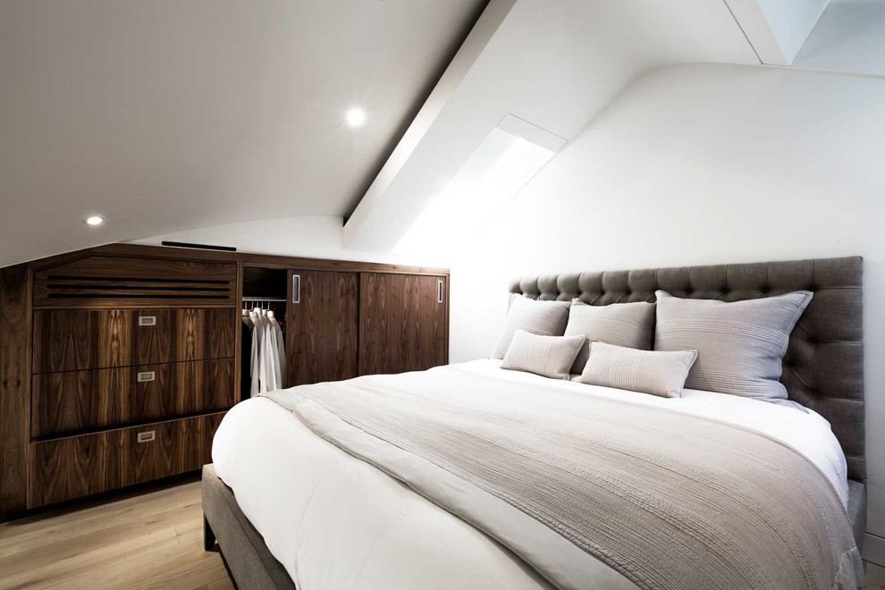 Design ideas for a medium sized contemporary bedroom in London with white walls, dark hardwood flooring and no fireplace.