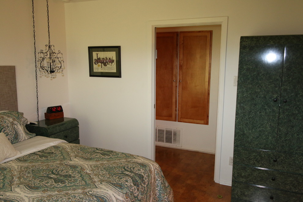 Medium sized eclectic master bedroom in Austin with white walls, porcelain flooring, no fireplace and brown floors.