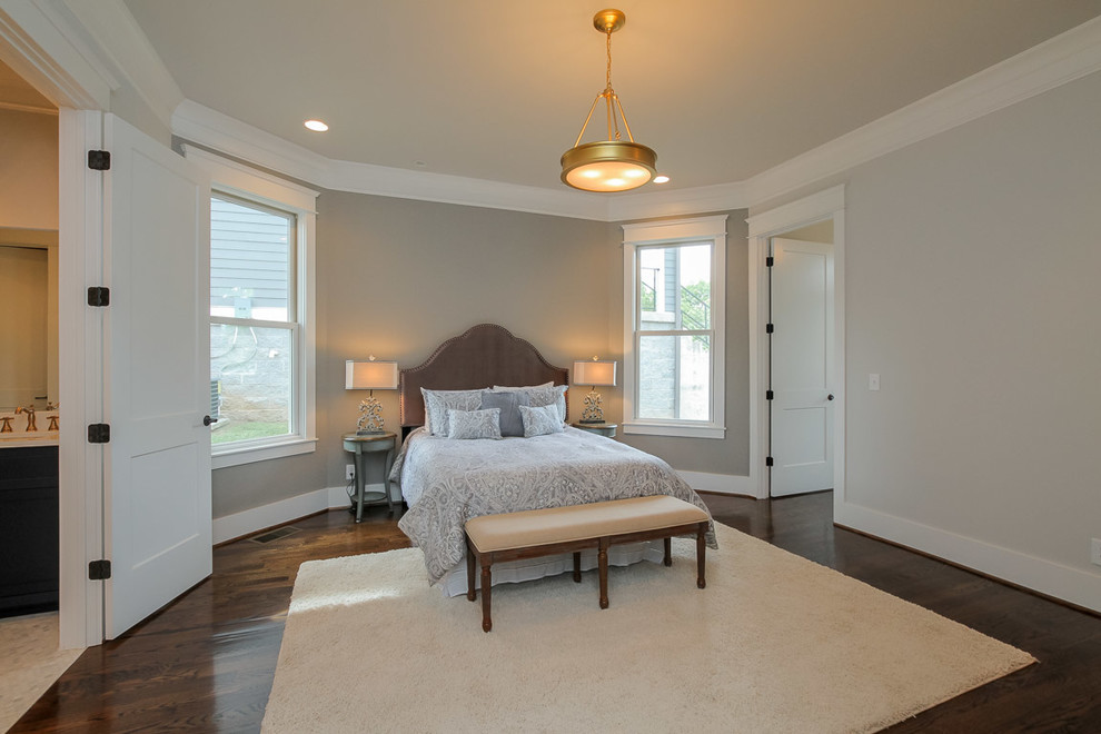 Mid-sized elegant master dark wood floor bedroom photo in Nashville with gray walls and a standard fireplace